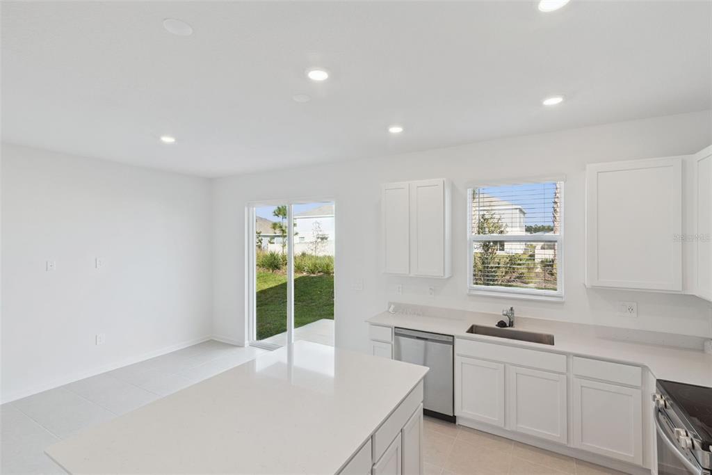 2653 Skyline Loop Kissimmee, FL 34758 - Photo 12 of 42 a large white kitchen with a window