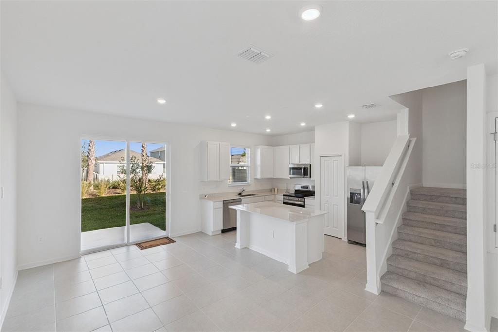 2653 Skyline Loop Kissimmee, FL 34758 - Photo 14 of 42 a open kitchen with white cabinets and white appliances