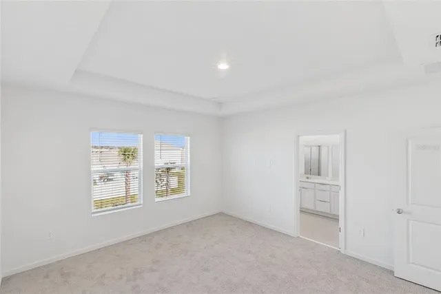 an empty room with windows and cabinet