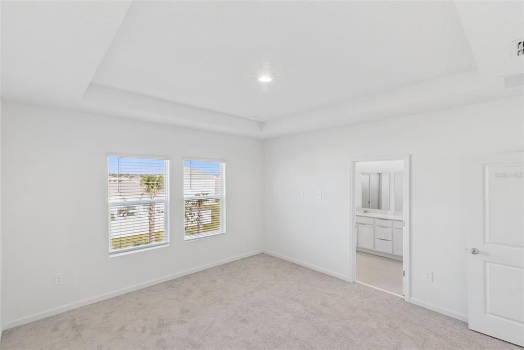 2653 Skyline Loop Kissimmee, FL 34758 - Photo 17 of 42 an empty room with windows and cabinet
