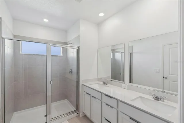a bathroom with a shower sink and mirror