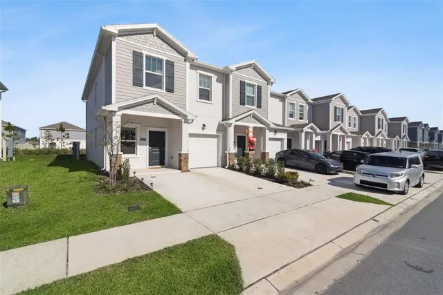 a front view of a house with a yard