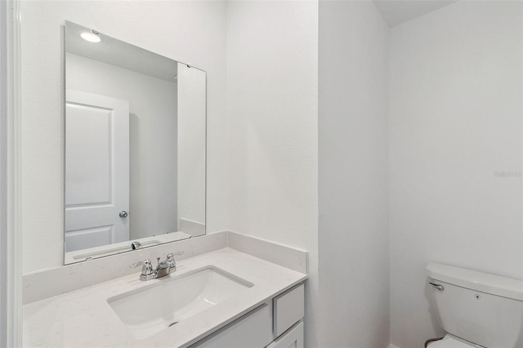 2653 Skyline Loop Kissimmee, FL 34758 - Photo 27 of 42 a bathroom with a sink toilet and vanity