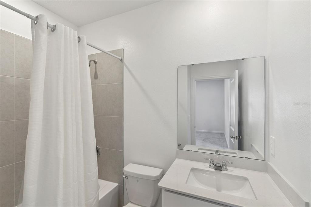 2653 Skyline Loop Kissimmee, FL 34758 - Photo 28 of 42 a bathroom with a sink toilet and shower