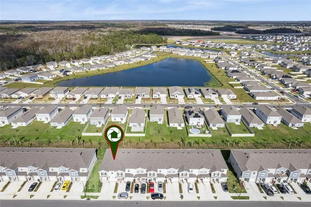aerial view of a house with a yard