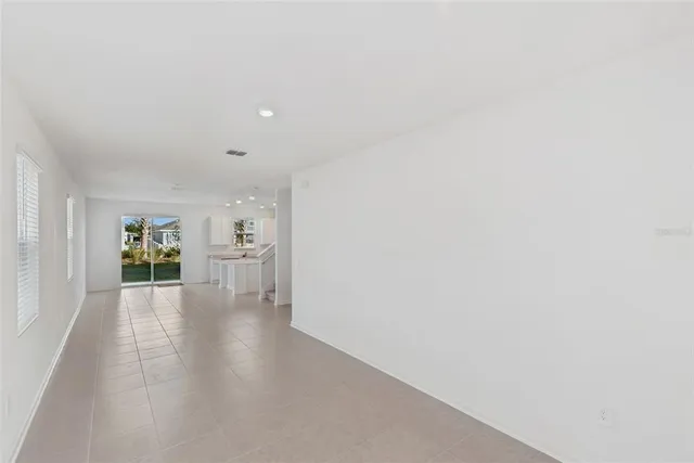 a view of a livingroom with wooden floor and a fireplace