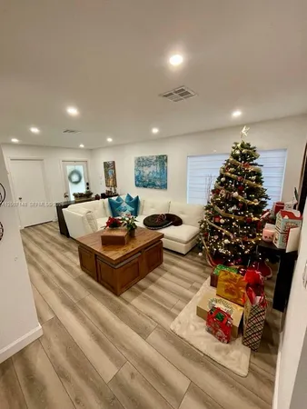 a living room with furniture and a christmas tree
