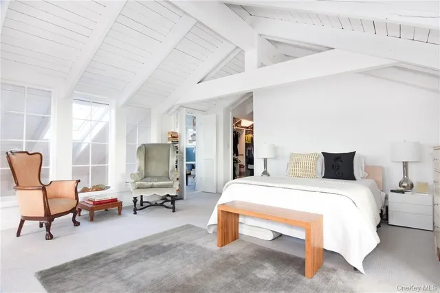 a bedroom with a bed and chair