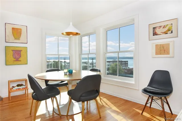 a dining room with furniture and wooden floor
