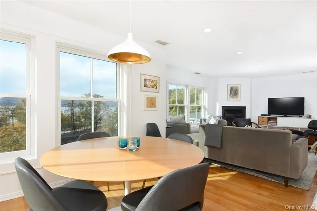 a living room with furniture a flat screen tv and a large window