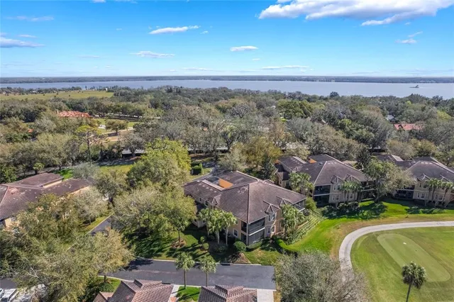 an aerial view of a house with yard and outdoor seating
