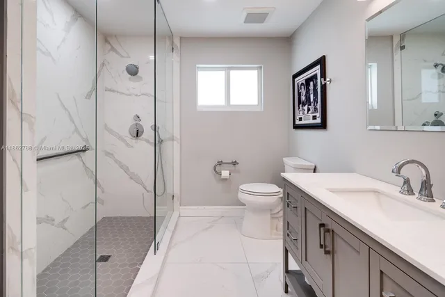 a bathroom with a sink toilet and shower