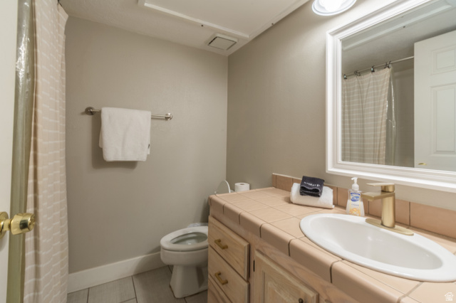 860 South Village Road, Unit Y8 St. George, UT 84770 - Photo 10 of 29 Full bathroom featuring vanity, curtained shower, and light tile patterned flooring