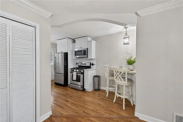 a kitchen with stainless steel appliances a refrigerator and a stove top oven