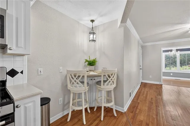a view of a dining room with furniture and wooden floor