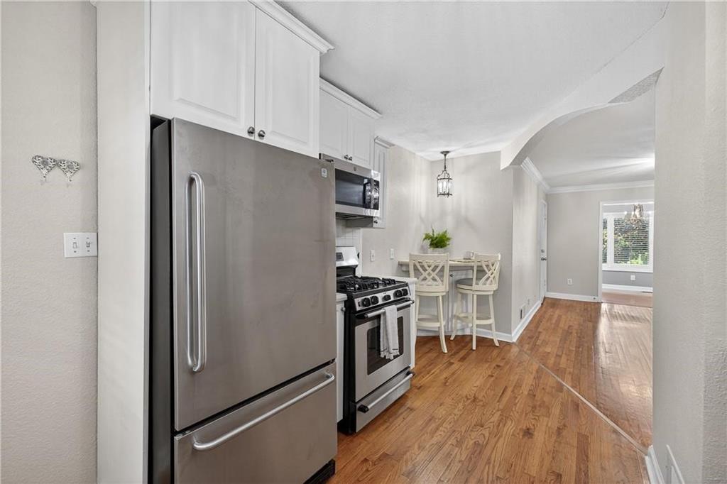 1879 Johnson Road Northeast, Unit 3 Atlanta, GA 30306 - Photo 15 of 38 a kitchen with stainless steel appliances a refrigerator and a stove top oven