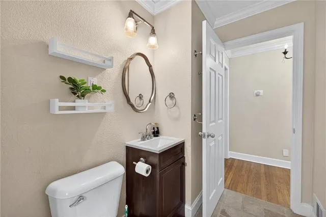 a bathroom with a toilet a sink and a mirror