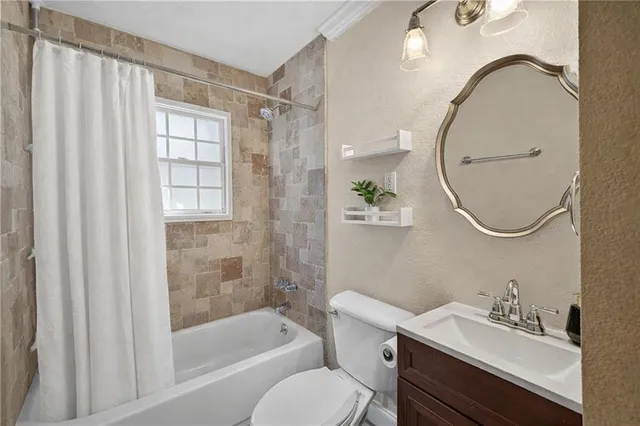 a bathroom with a sink toilet and a mirror