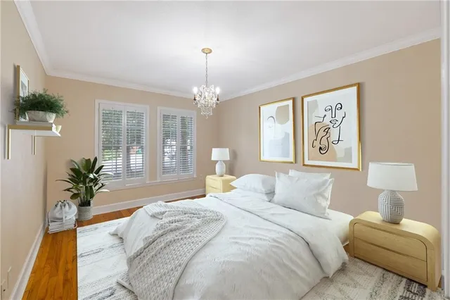 a bedroom with a large bed and a chandelier