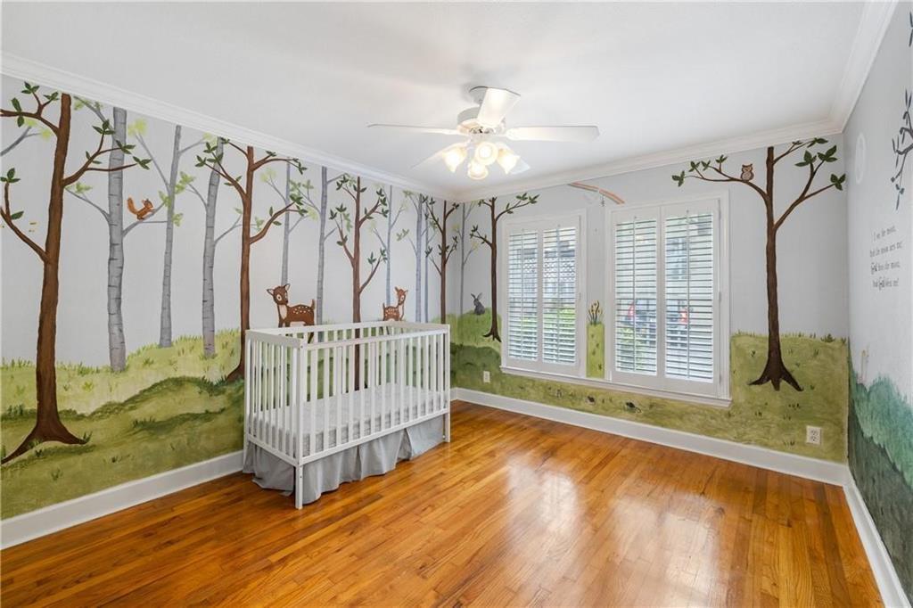 1879 Johnson Road Northeast, Unit 3 Atlanta, GA 30306 - Photo 25 of 38 a view of a bedroom with wooden floor and windows