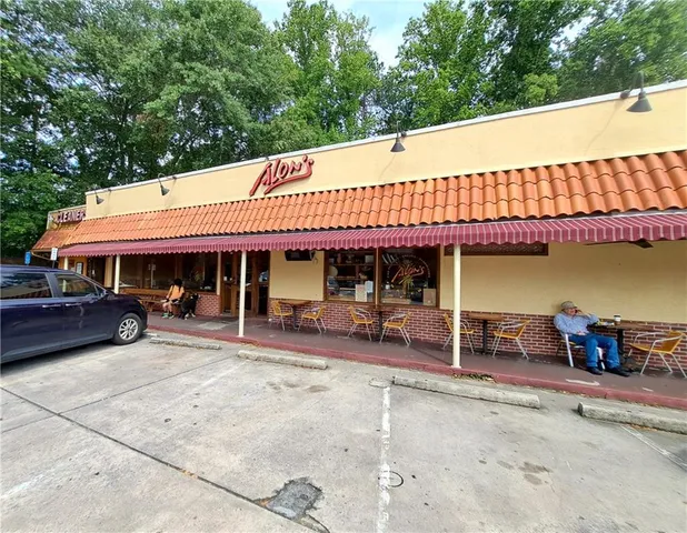 a view of a patio with table and chairs under an umbrella with wooden fence