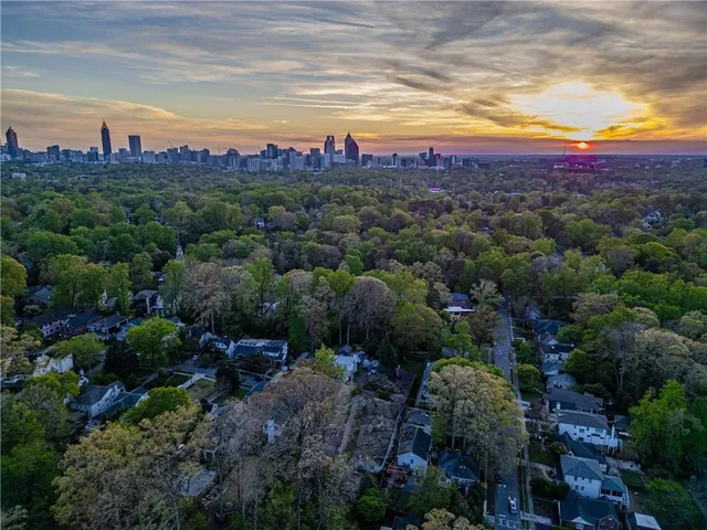 a view of a city with lots of plants and mountain view