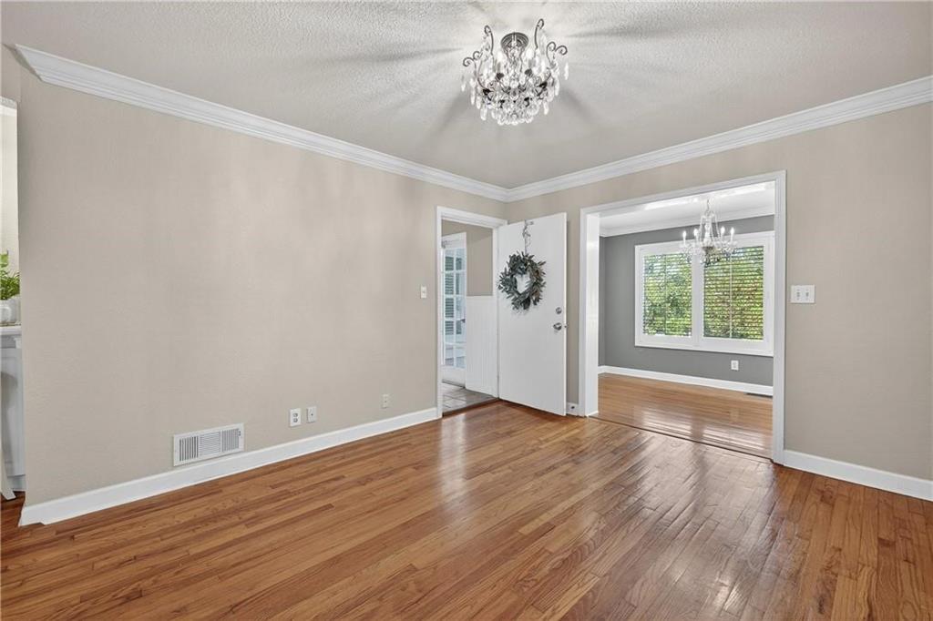 1879 Johnson Road Northeast, Unit 3 Atlanta, GA 30306 - Photo 6 of 38 a view of an empty room with a window and wooden floor