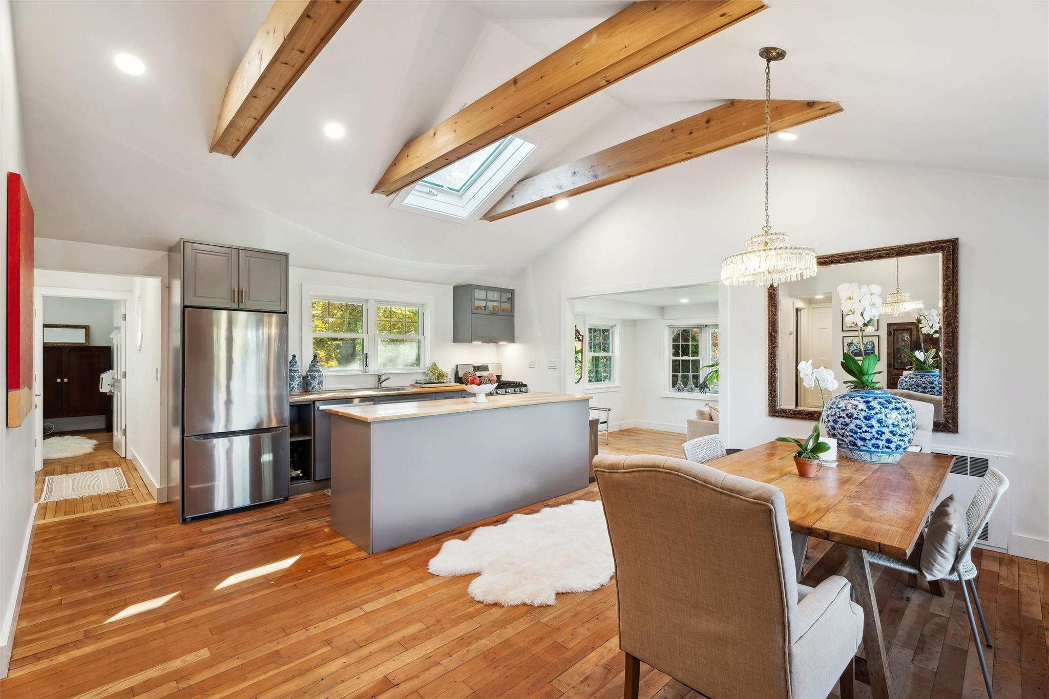 22 Greenfield Road Southampton, NY 11968 - Photo 1 of 1 Dining space with light wood-type flooring, beam ceiling, and a skylight