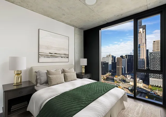 a bedroom with a large bed and a night stand