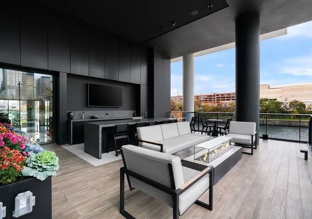 a living room with patio furniture and a flat screen tv