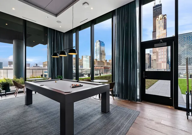 a room with pool table and windows