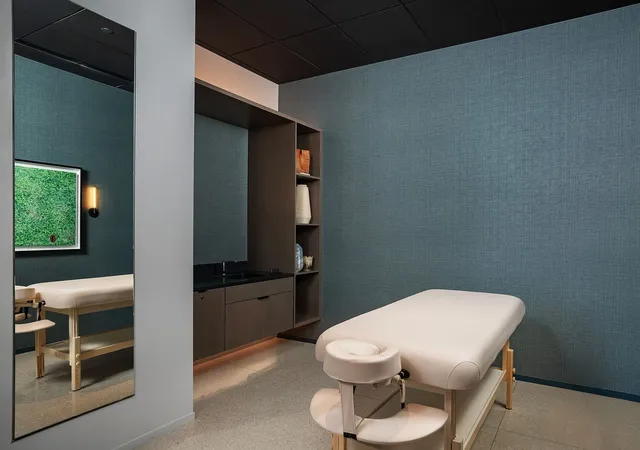 a white toilet sitting next to a bathroom sink and a mirror