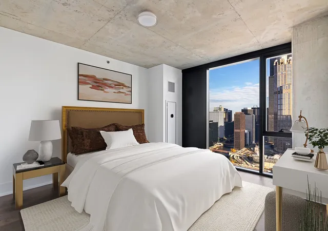 a bedroom with a bed and a large mirror