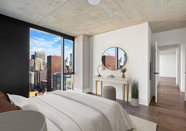a view of a bedroom with wooden floor and a fireplace