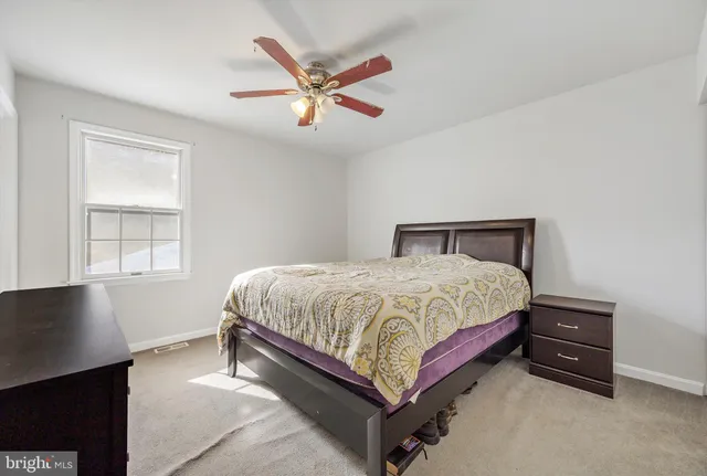 a spacious bedroom with a bed and a window