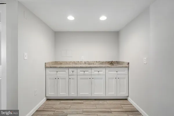 a view of a kitchen with granite countertop cabinets