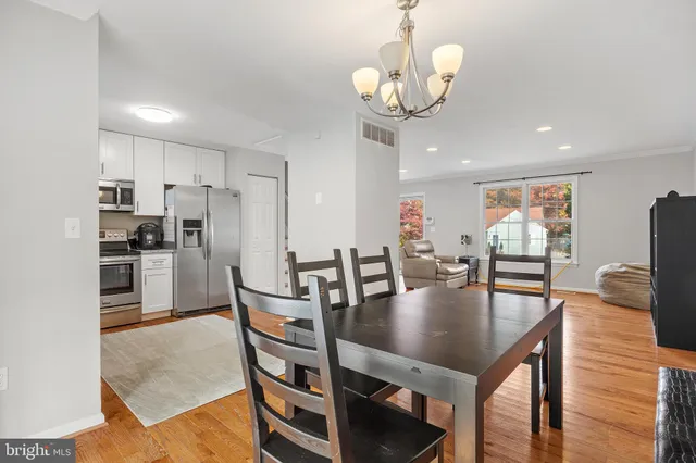 a view of kitchen and dining room with wooden floor