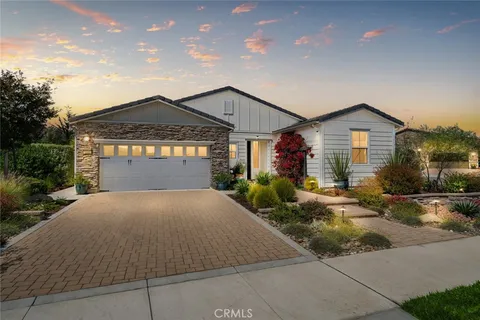 a living room with furniture a fireplace and a floor to ceiling window