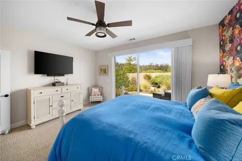 a bedroom that has a bed and a desk