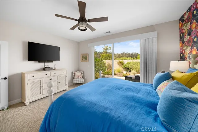 a bedroom that has a bed and a desk