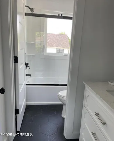 a bathroom with a bathtub and a window