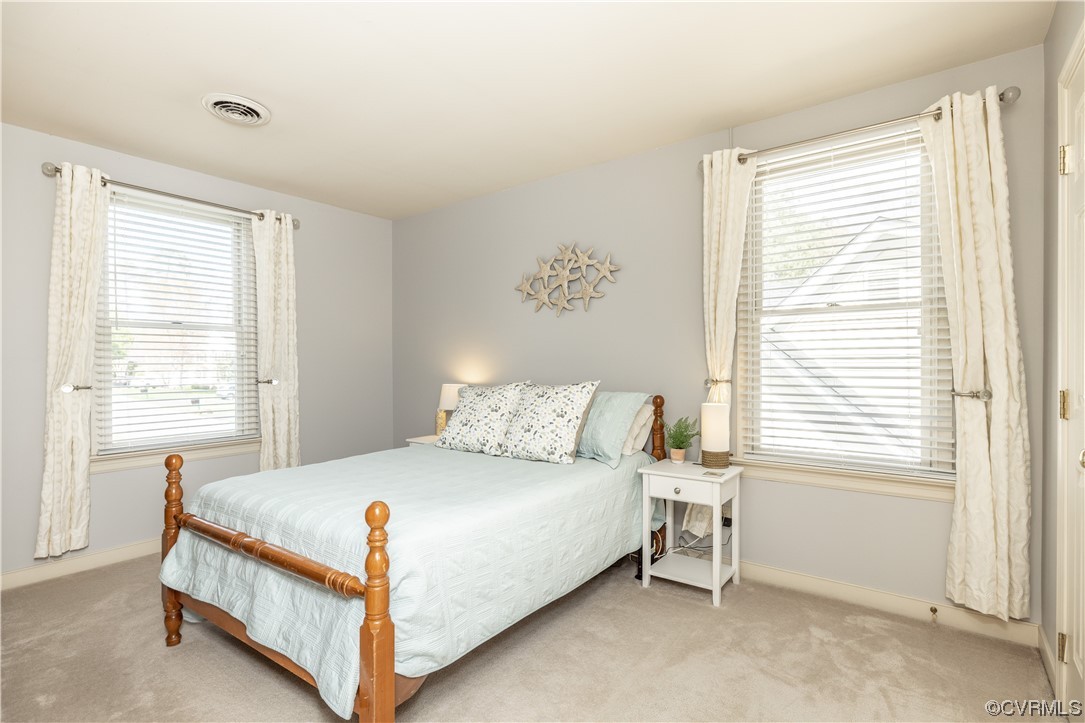 13900 Sagebrook Road Midlothian, VA 23112 - Photo 27 of 44 a large bed sitting in a bedroom next to a window