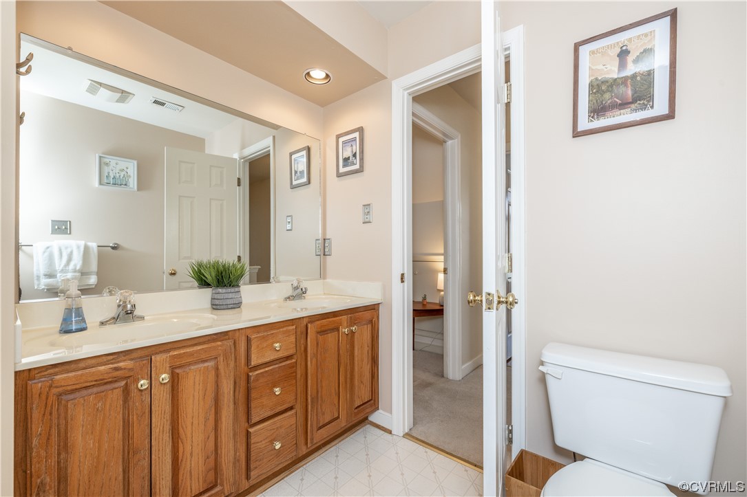 13900 Sagebrook Road Midlothian, VA 23112 - Photo 28 of 44 a spacious bathroom with a double vanity sink toilet and shower