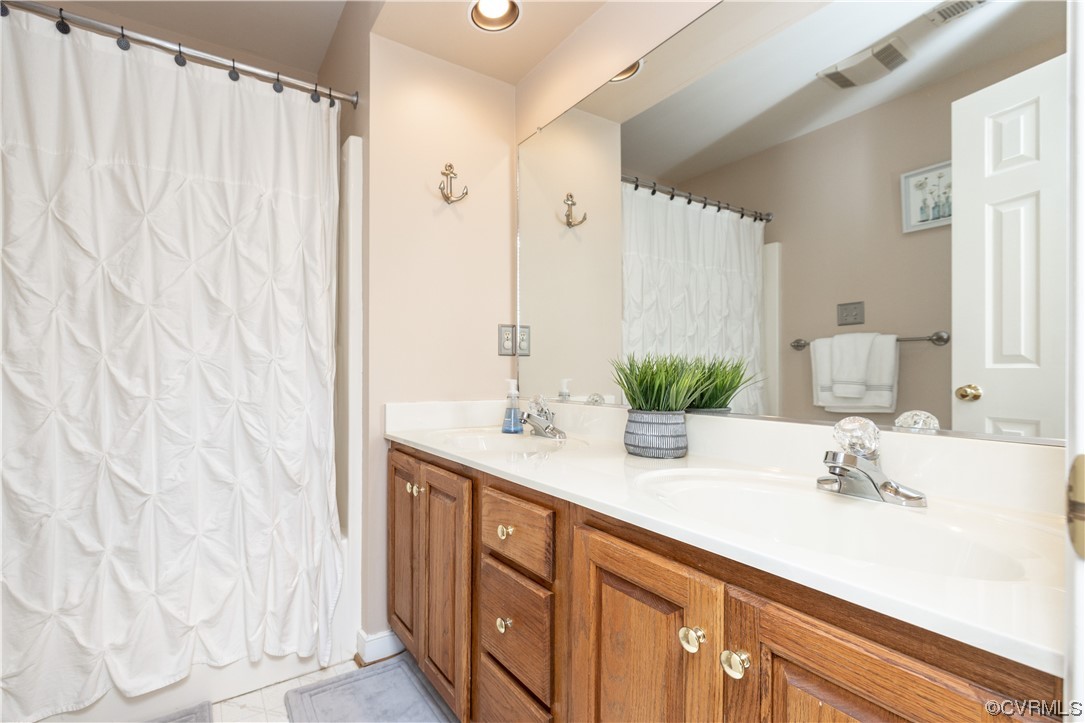 13900 Sagebrook Road Midlothian, VA 23112 - Photo 29 of 44 a bathroom with a double vanity sink and a mirror
