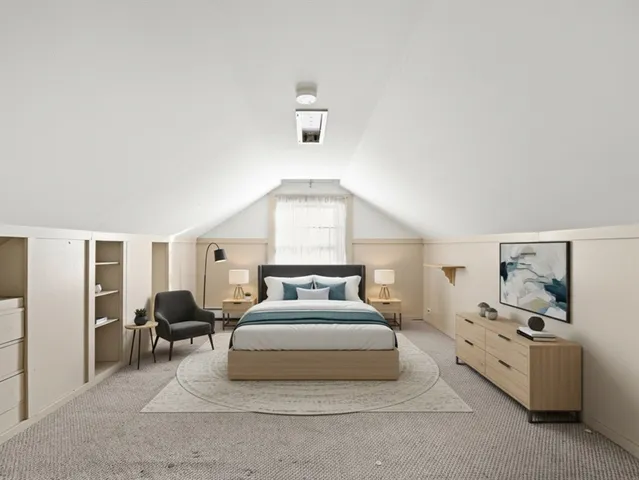 a spacious bedroom with a bed and window