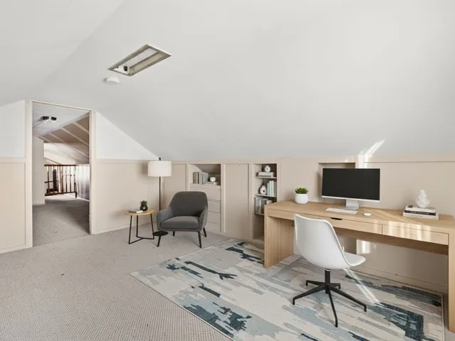 a work room with furniture and a flat screen tv