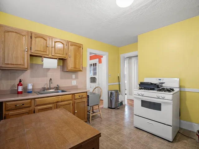 a kitchen with a stove a sink and a refrigerator