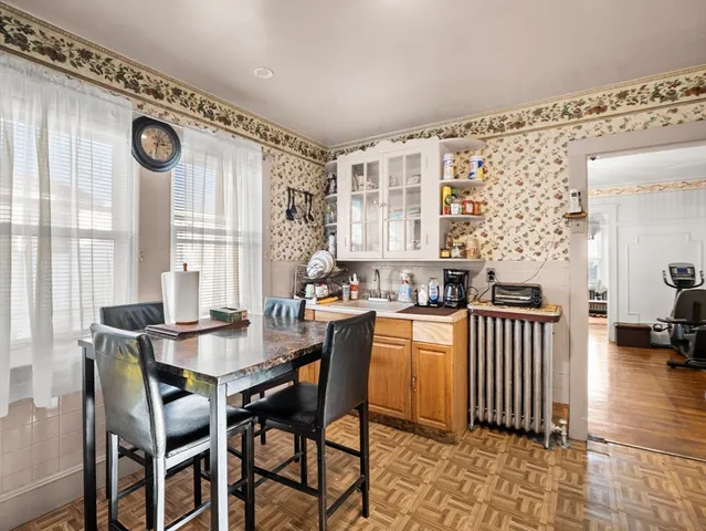a view of a dining room with furniture and chandelier