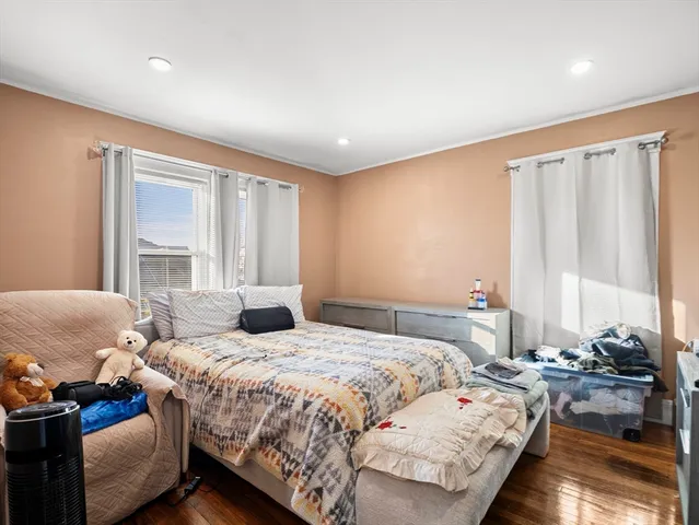 a bedroom with a bed and a large window