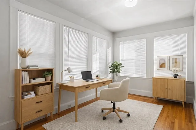 a view of a workspace with furniture and a window